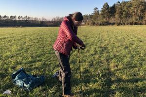 Taking a soil sample. Photo credit: Amy Cooper