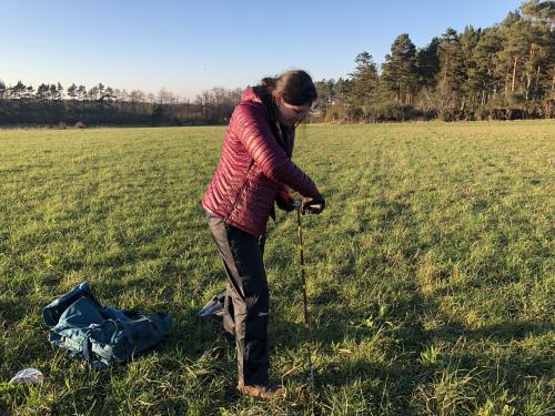 Taking a soil sample. Photo credit: Amy Cooper